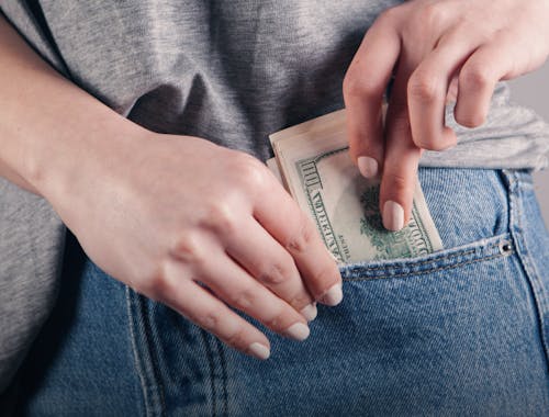 putting cash in jean pocket