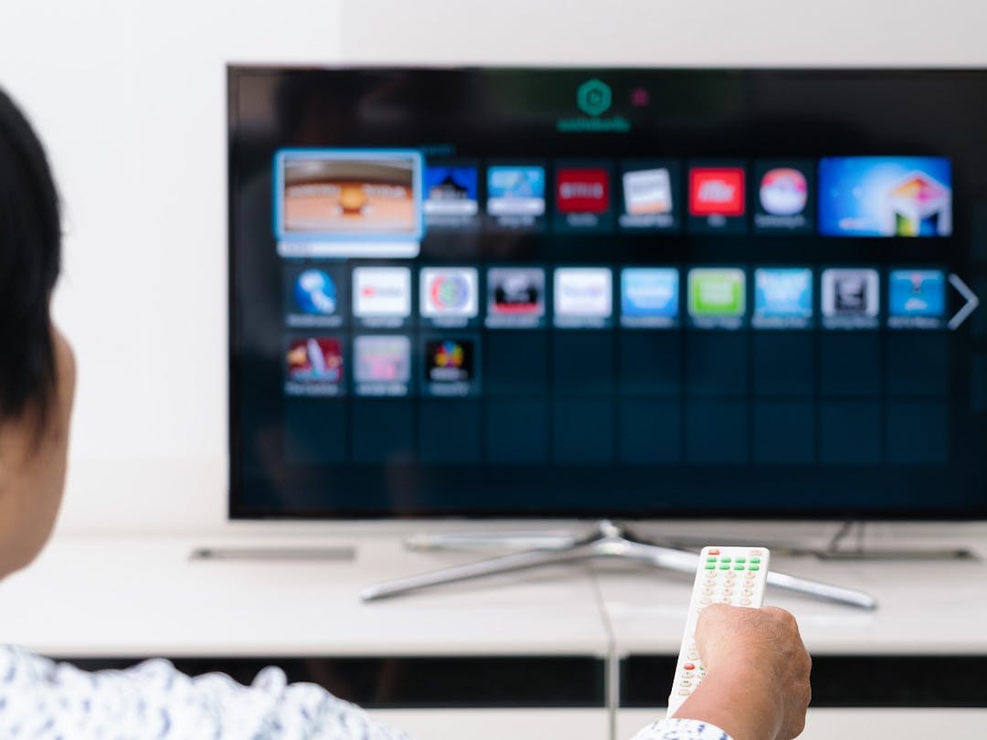 woman with remote and TV