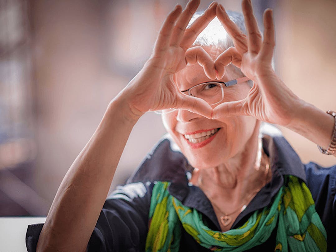 Senior woman making a heart with hands