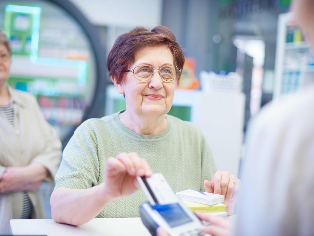 woman paying at the register with card