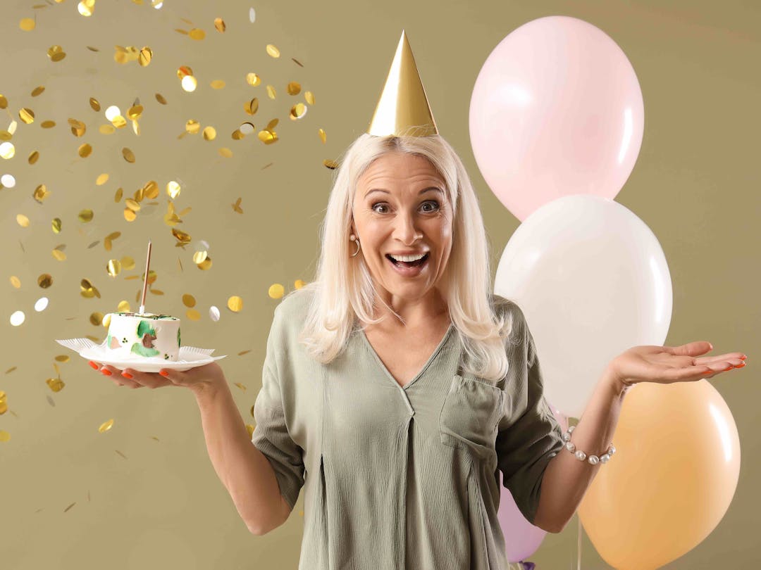 Mature woman birthday cake and balloons