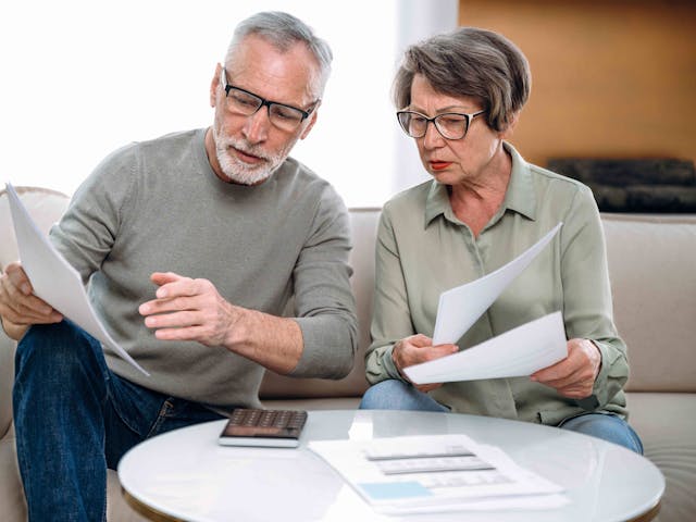 Mature couple looking at forms