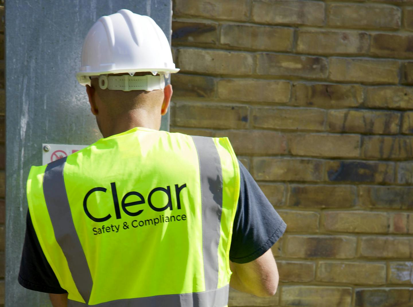Clear Safety inspector wearing hard hat and high vis