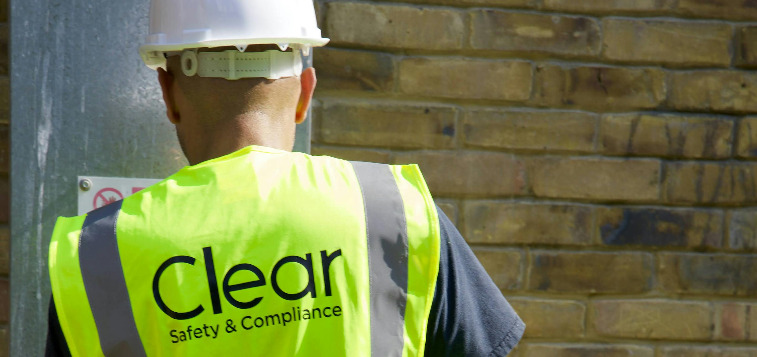 Clear Safety inspector wearing hard hat and high vis