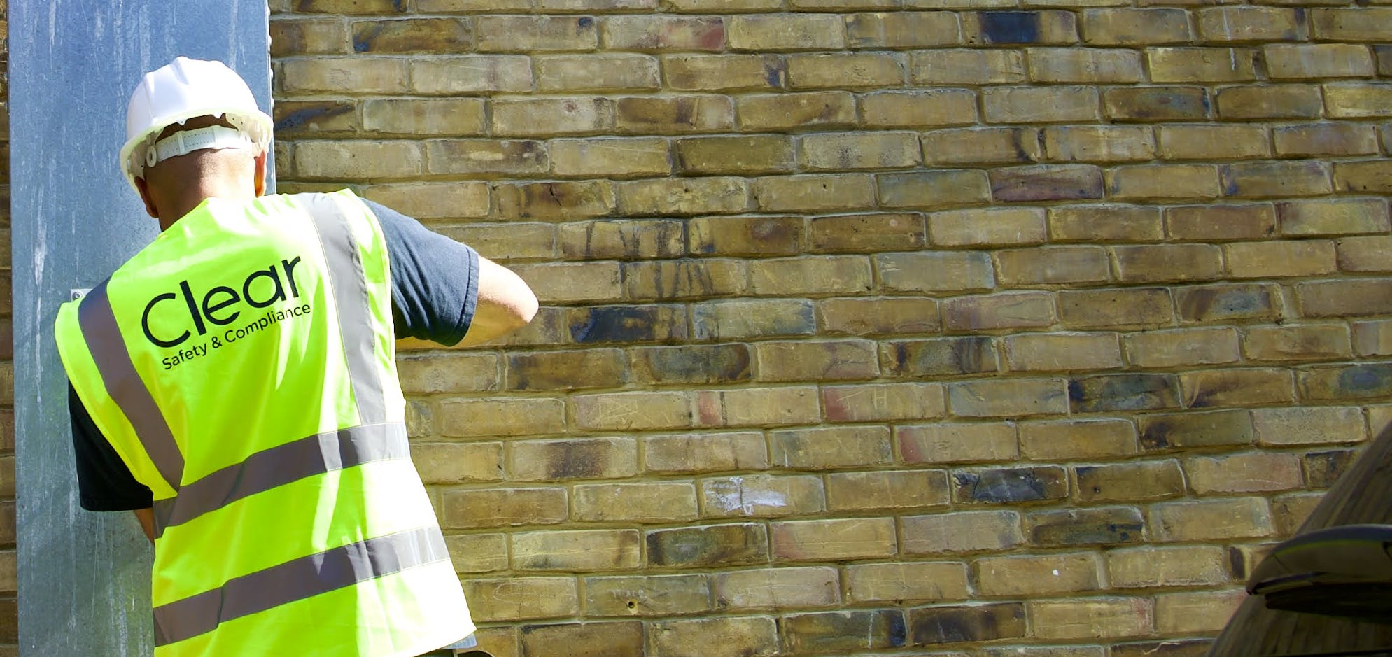 Clear Safety Inspector in PPE unlocking a ladder