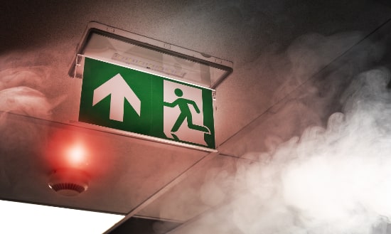 Fire exit signage sounded by smoke