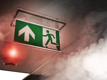 Fire exit signage sounded by smoke