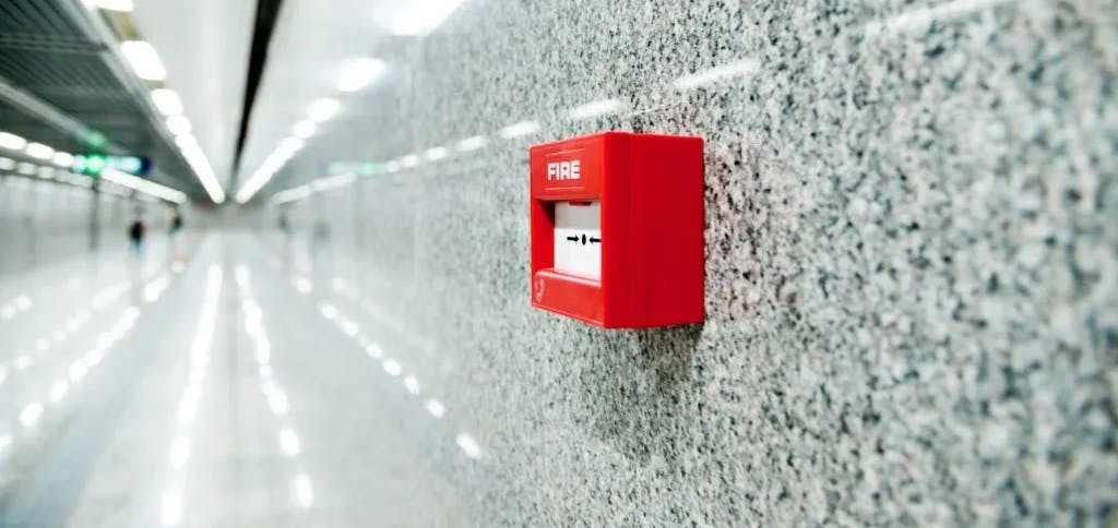fire alarm on wall of corridor