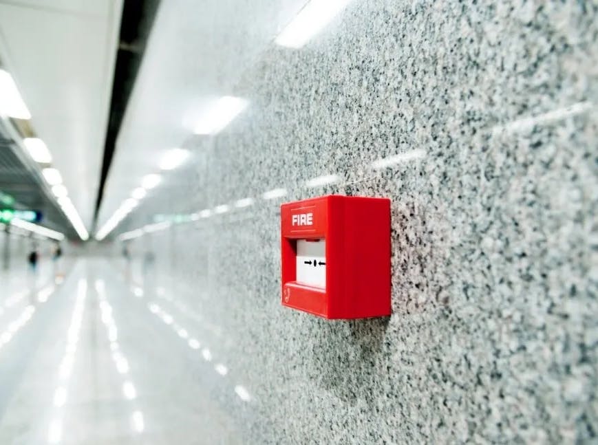 fire alarm on wall of corridor