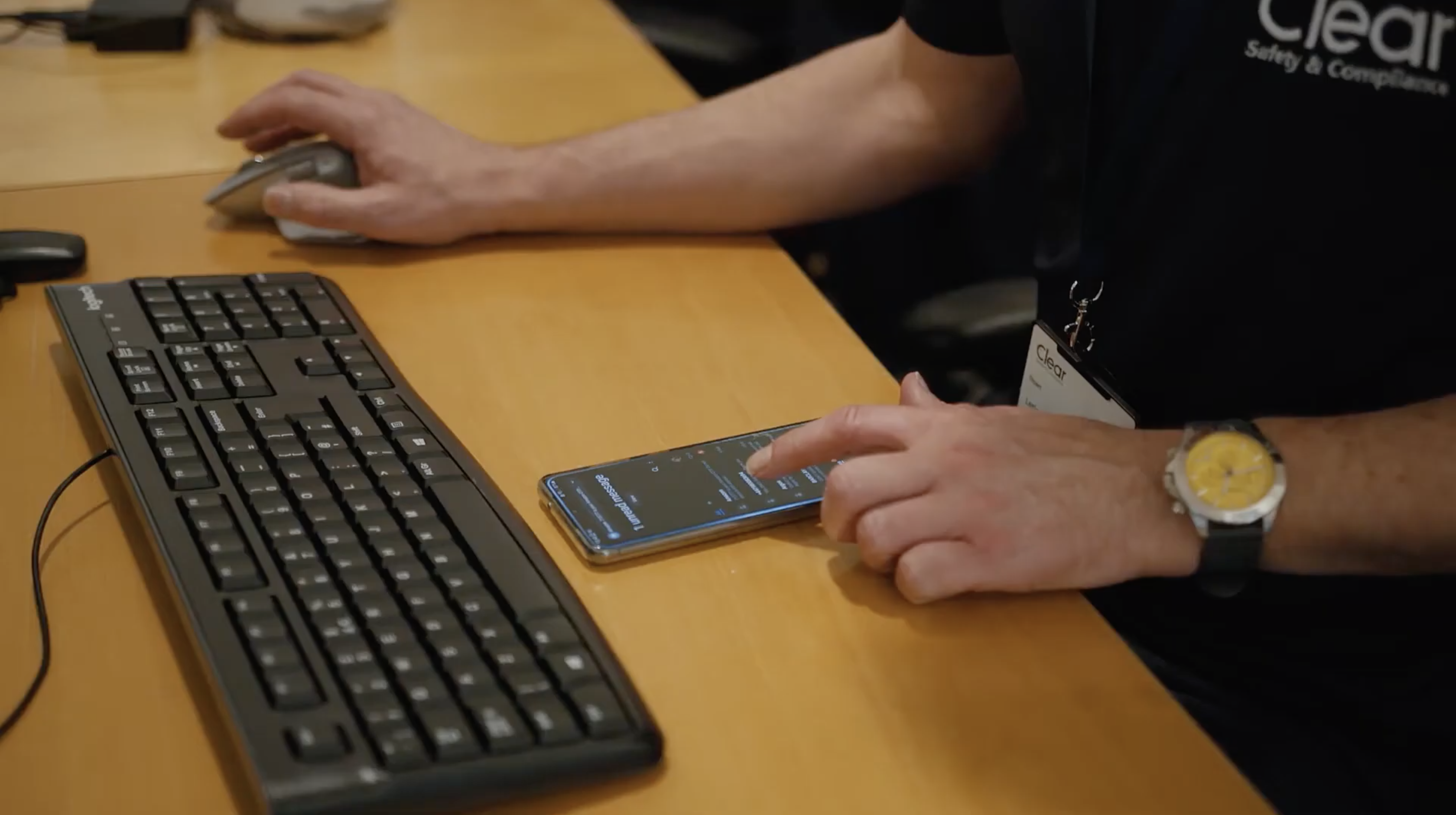 person using a phone at a desk
