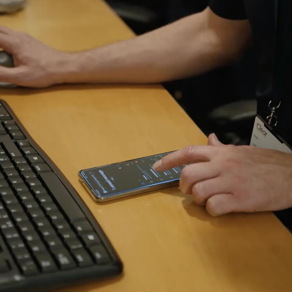 person using a phone at a desk