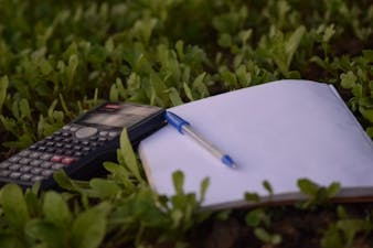 Image of a calculator and a notepad