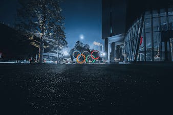 Image of the Olympic rings in a street at night