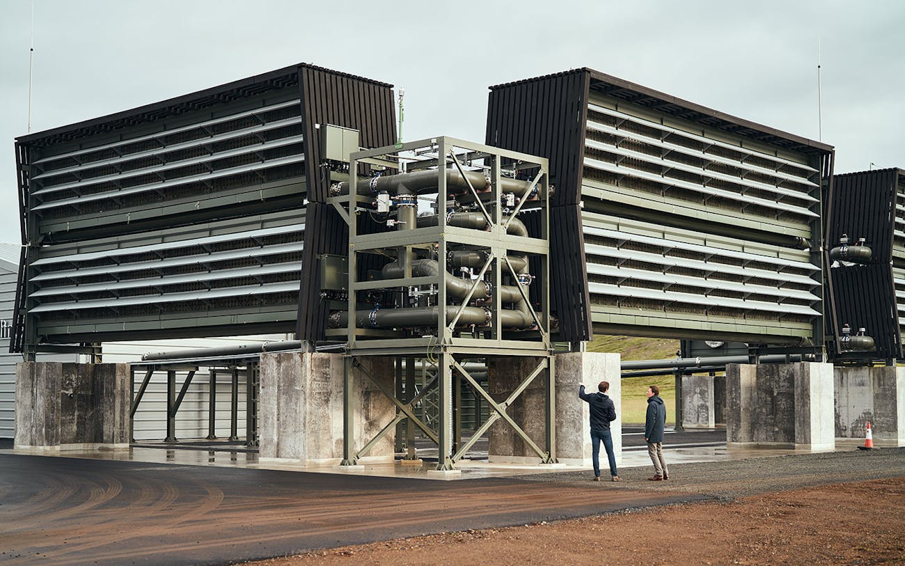 Co-CEOs Jan Wurzbacher and Christoph Gebald stand in front of the direct air capture plant Orca