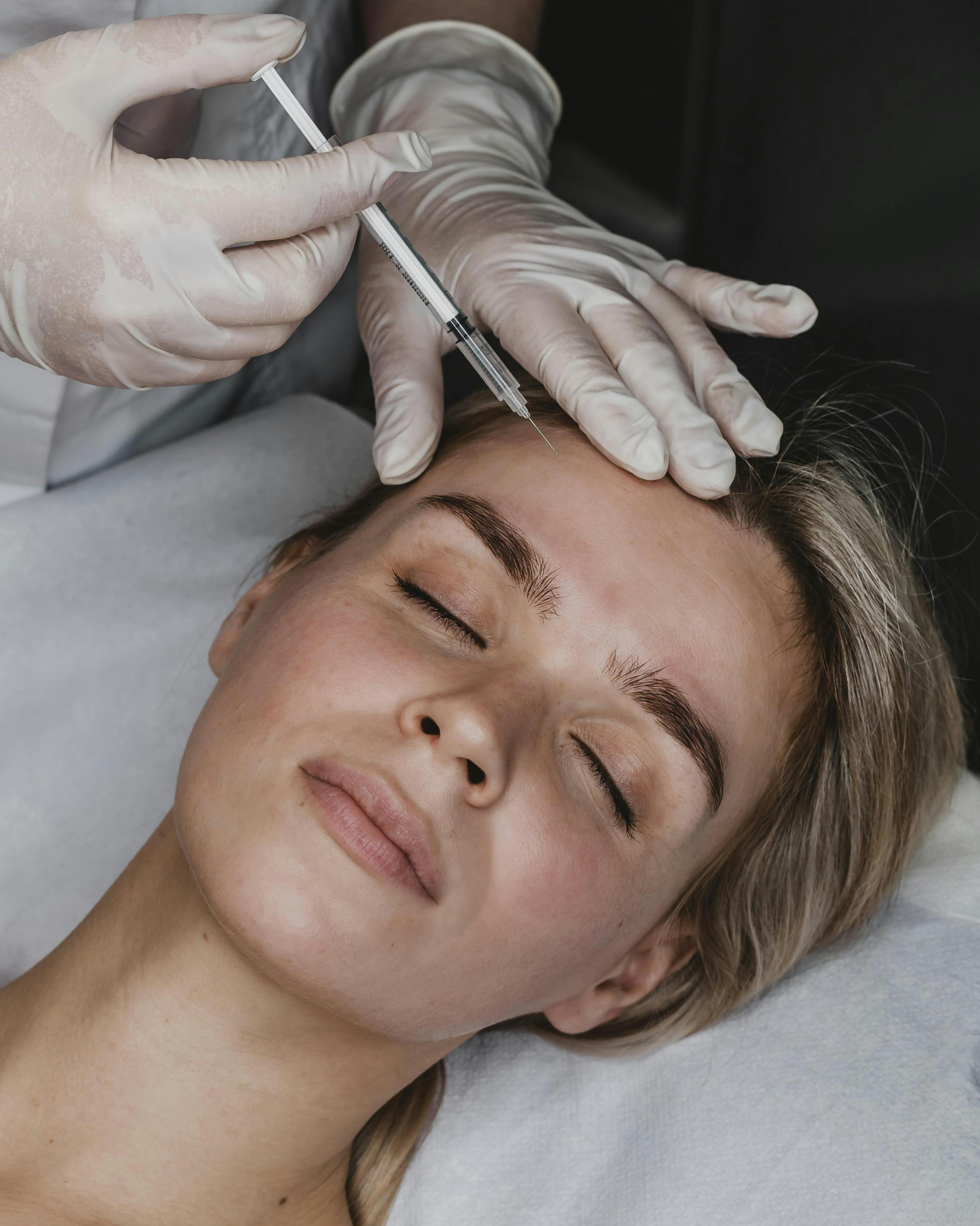A young female patient getting a filler injection