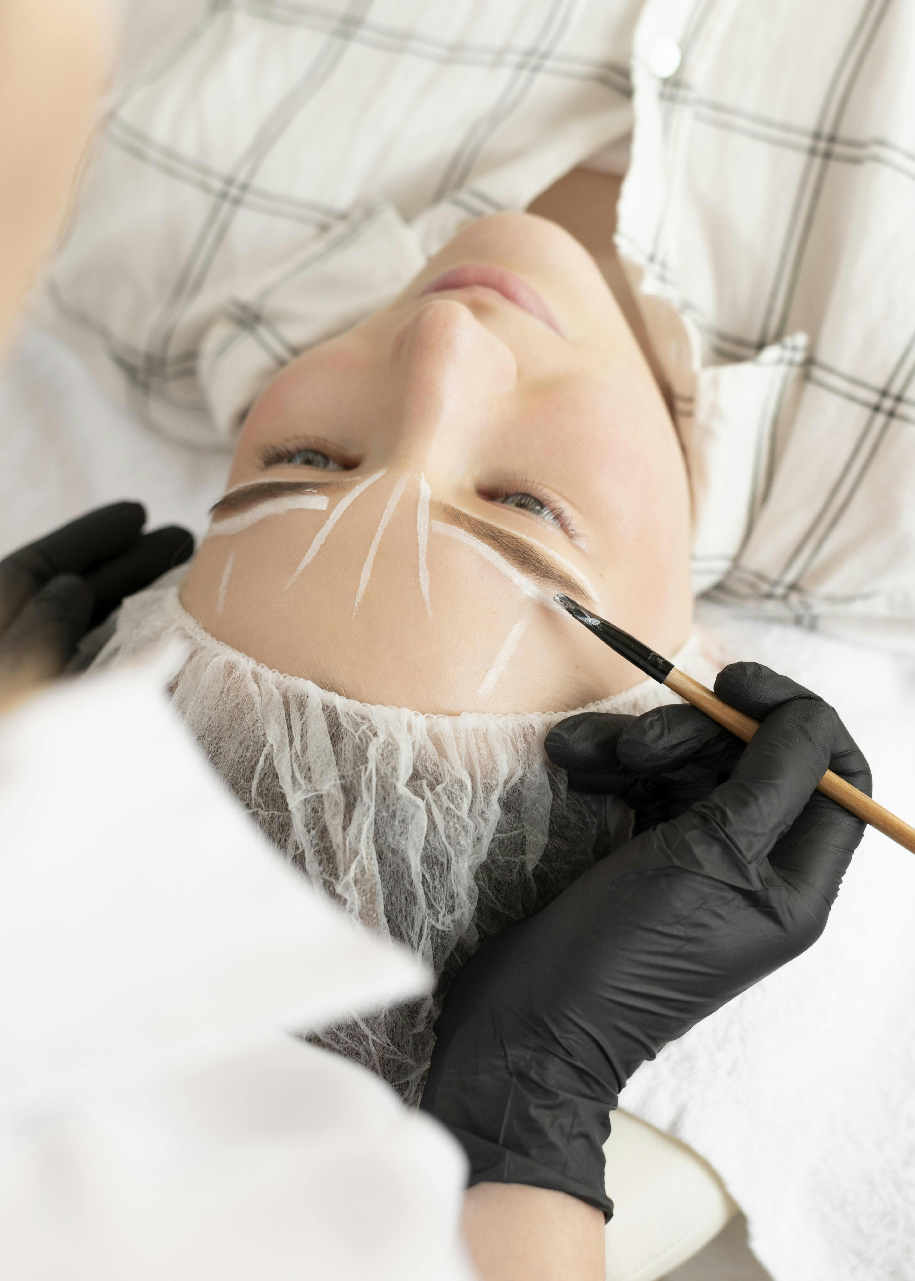 A female patient getting eyebrow aesthetic treatment