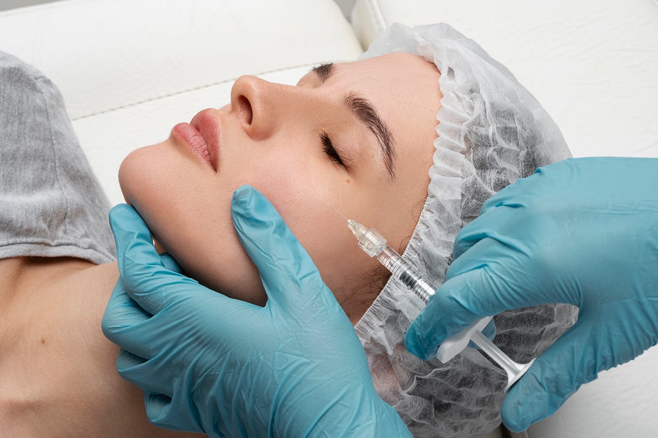 A woman having cheek filler treatment