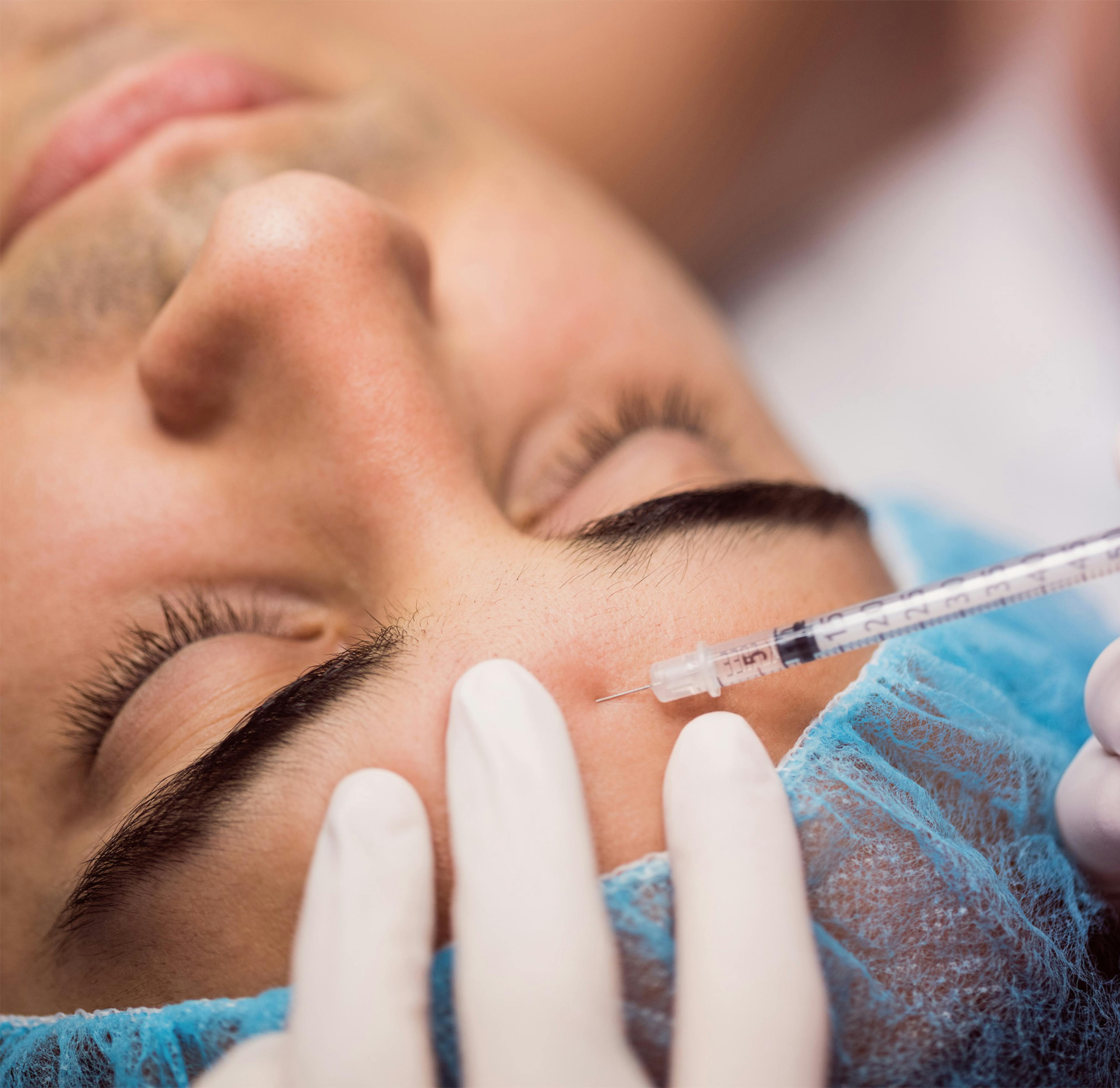 A male patient having an anti-wrinkle injection