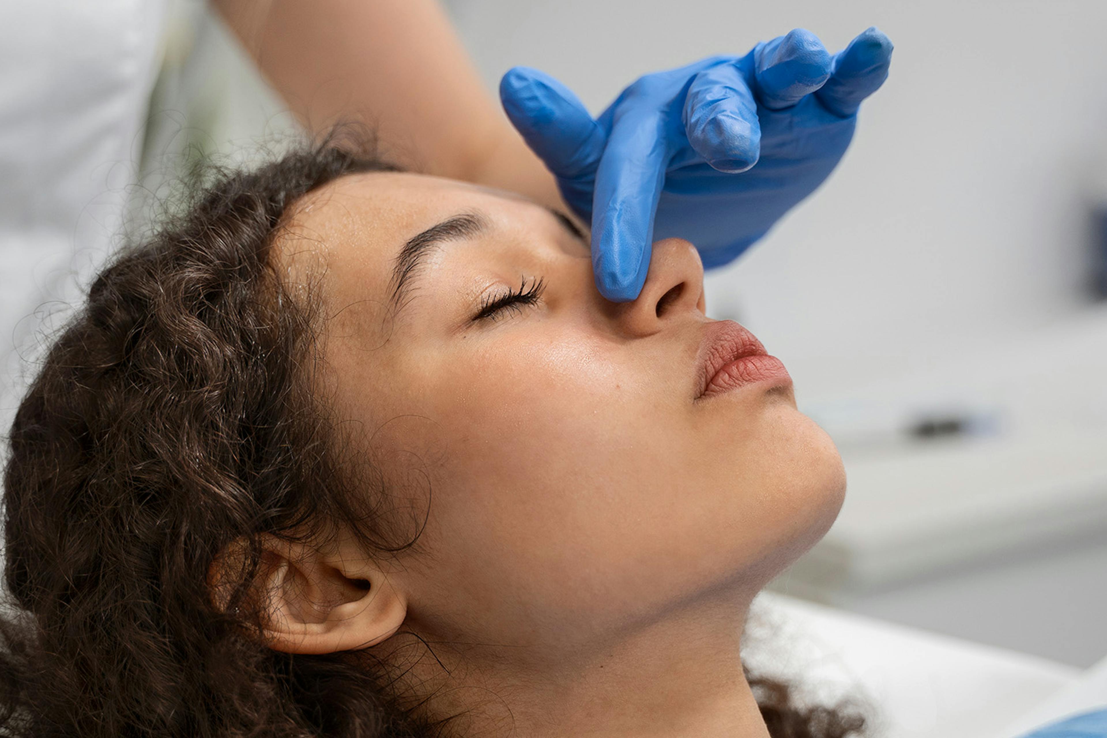 A female patient receiving non surgical rhinoplasty treatment