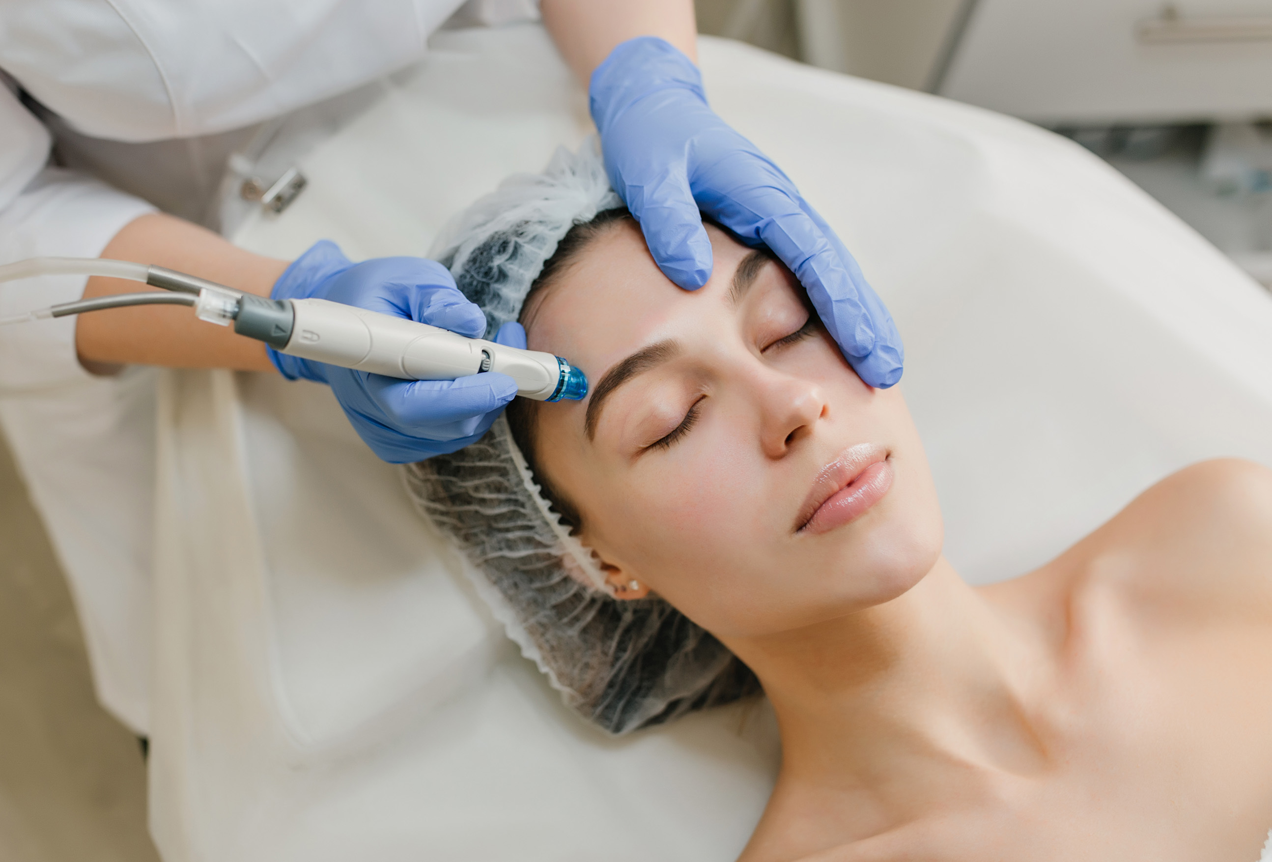 A female patient receiving Focus Facial laser treatment