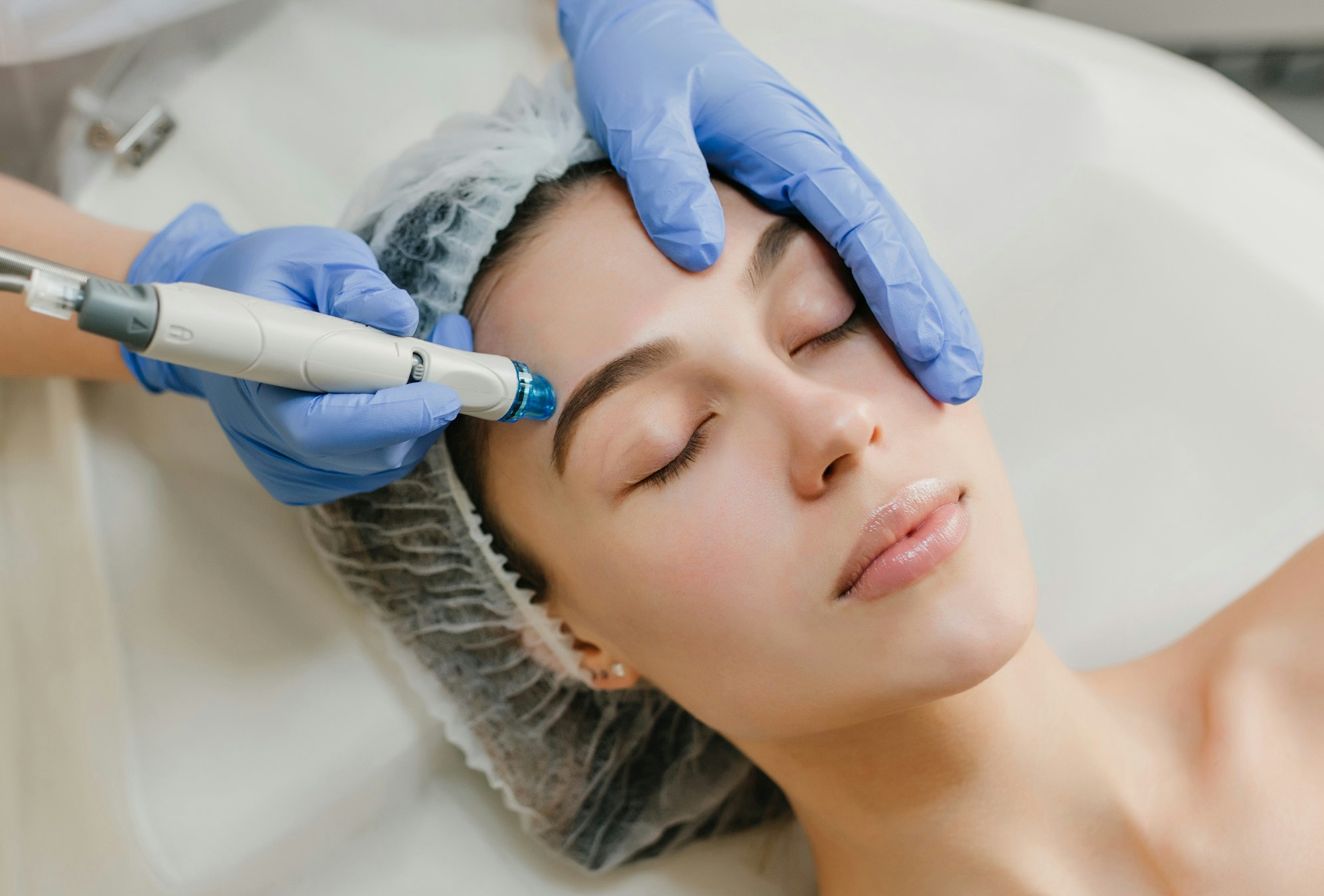 A female patient receiving Focus Facial laser treatment