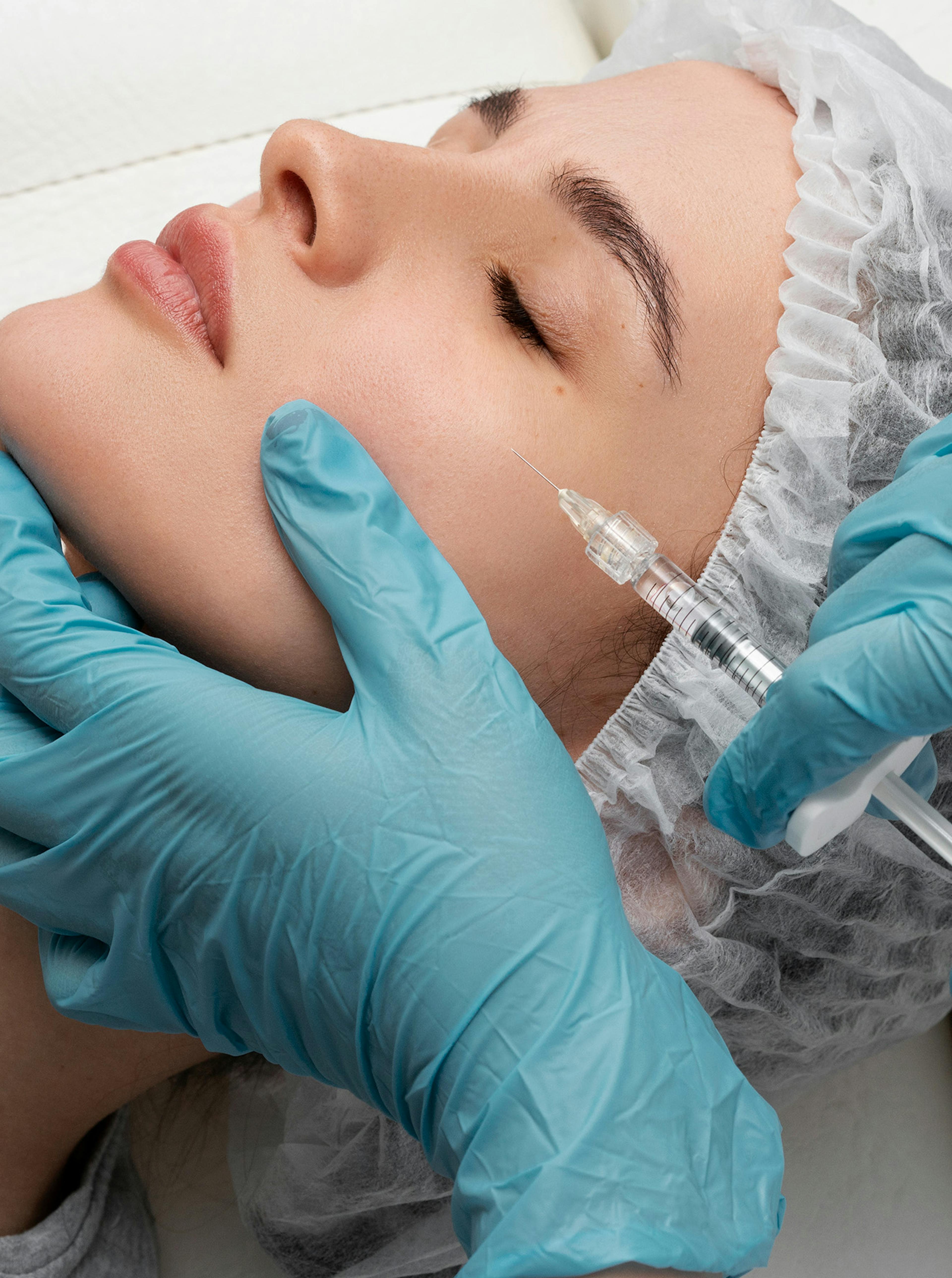 A woman having cheek filler treatment