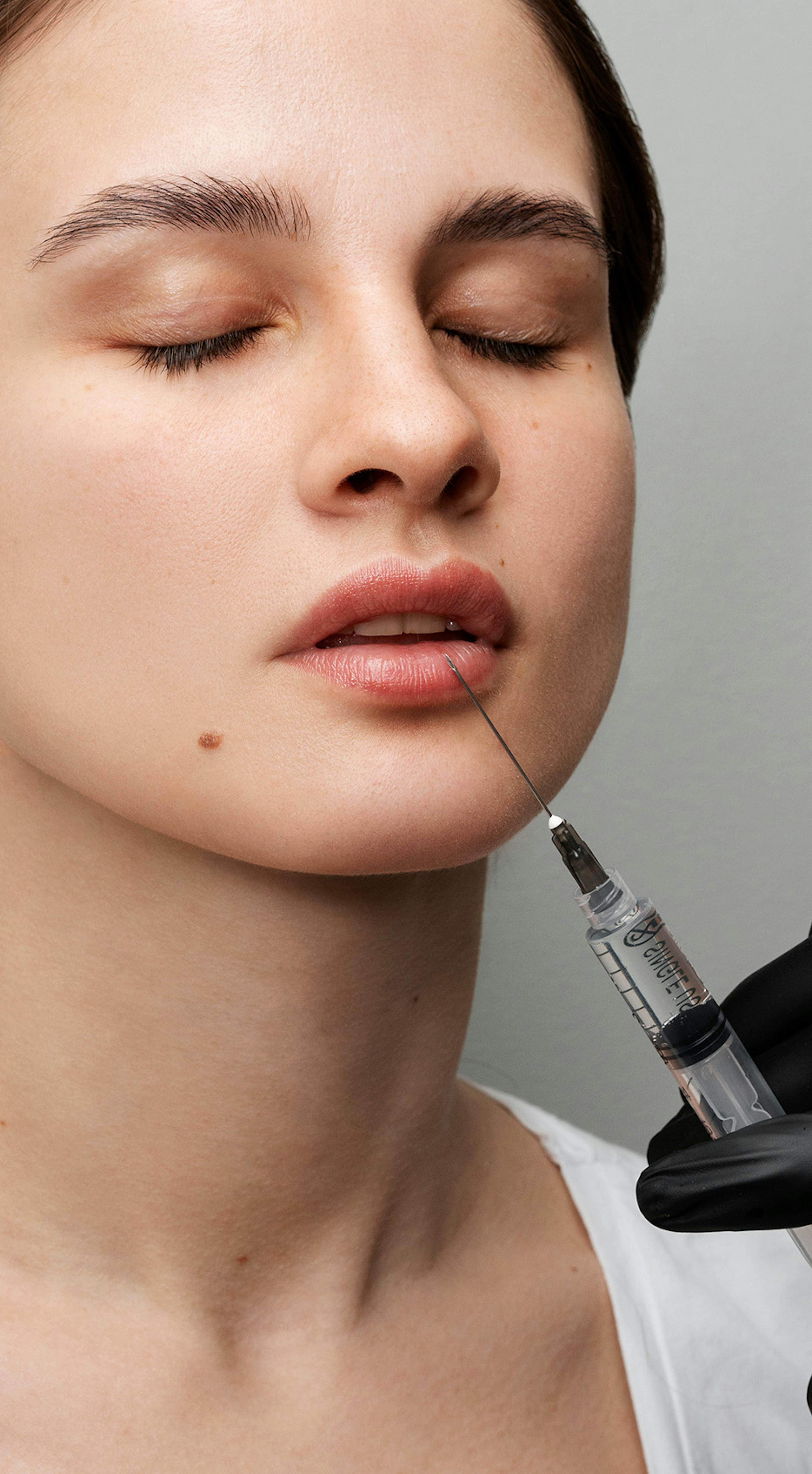 Lip filler training being performed on a woman