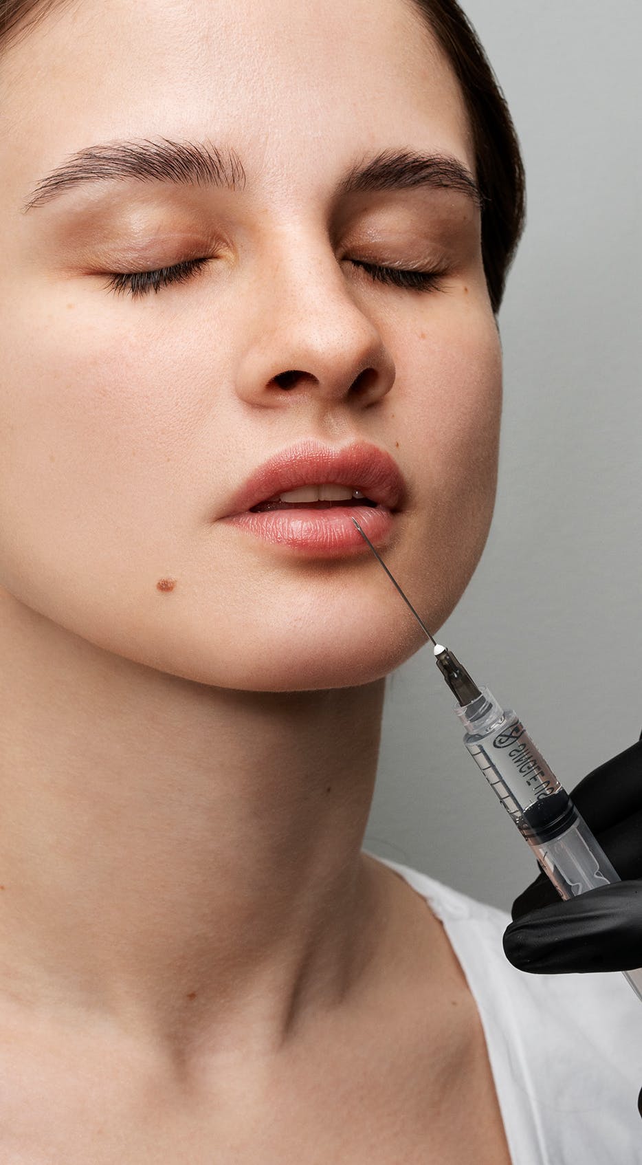 Lip filler training being performed on a woman