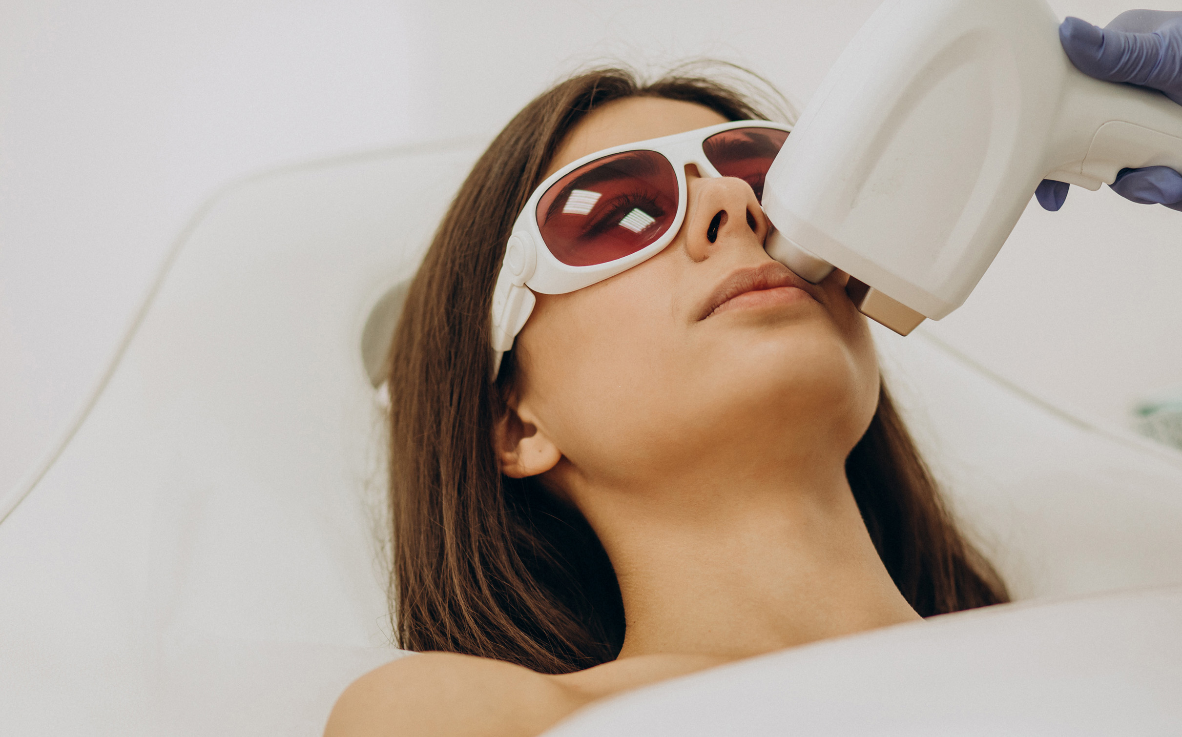 Woman having laser hair removal treatment