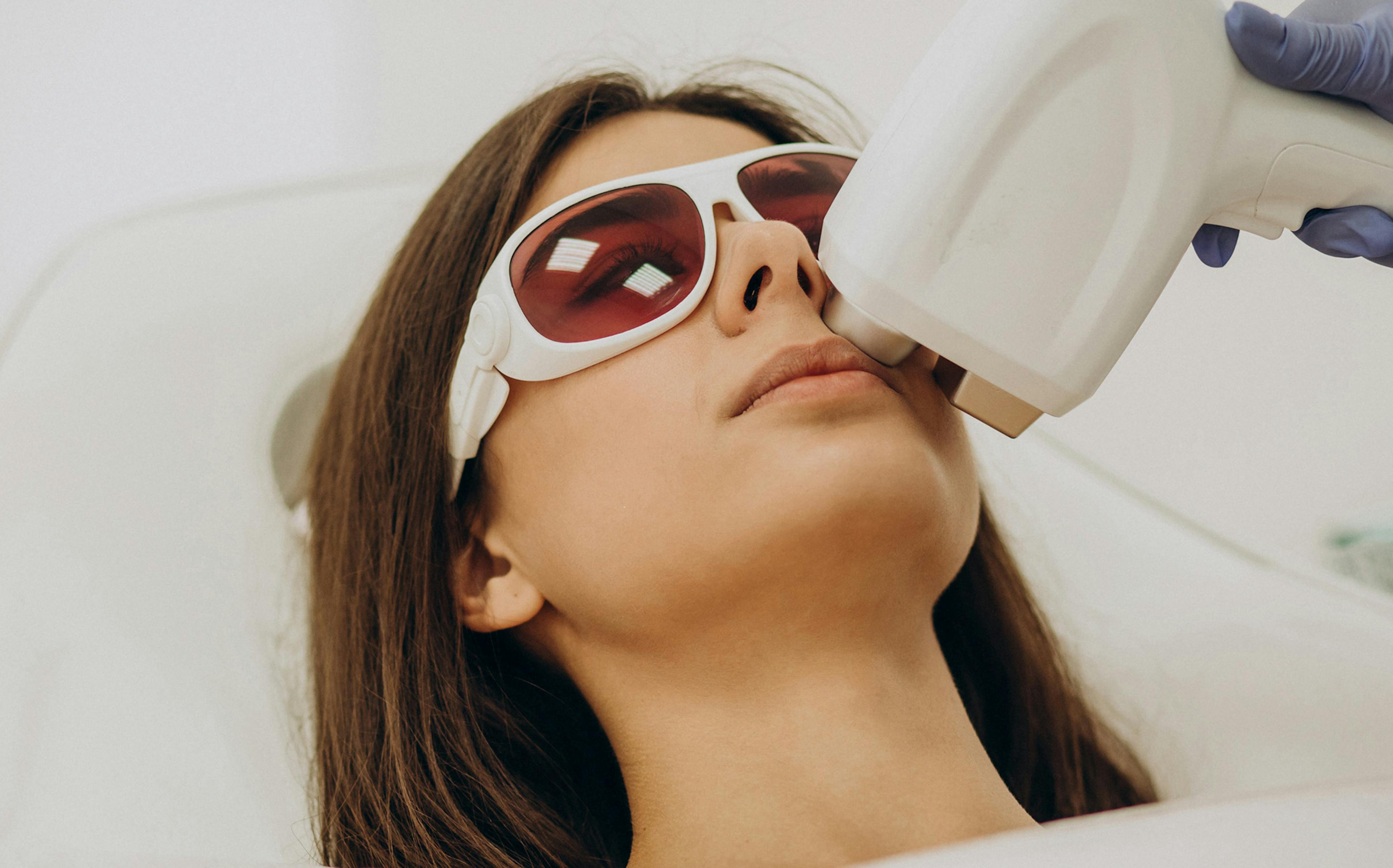 Woman having laser hair removal treatment