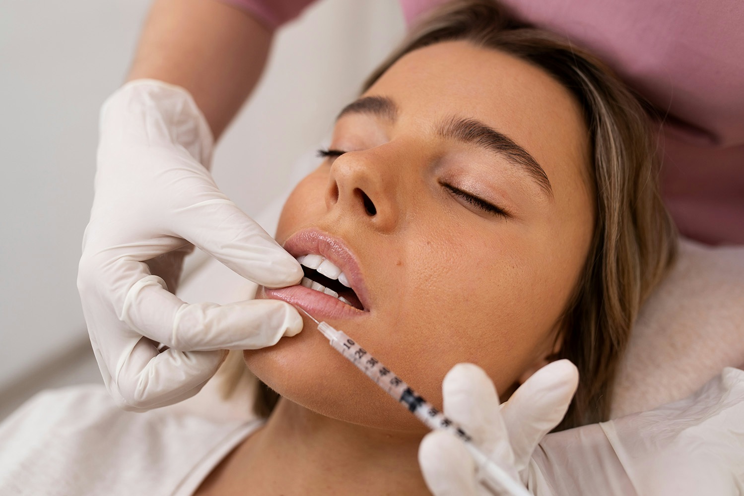 A female patient having lip filler treatment