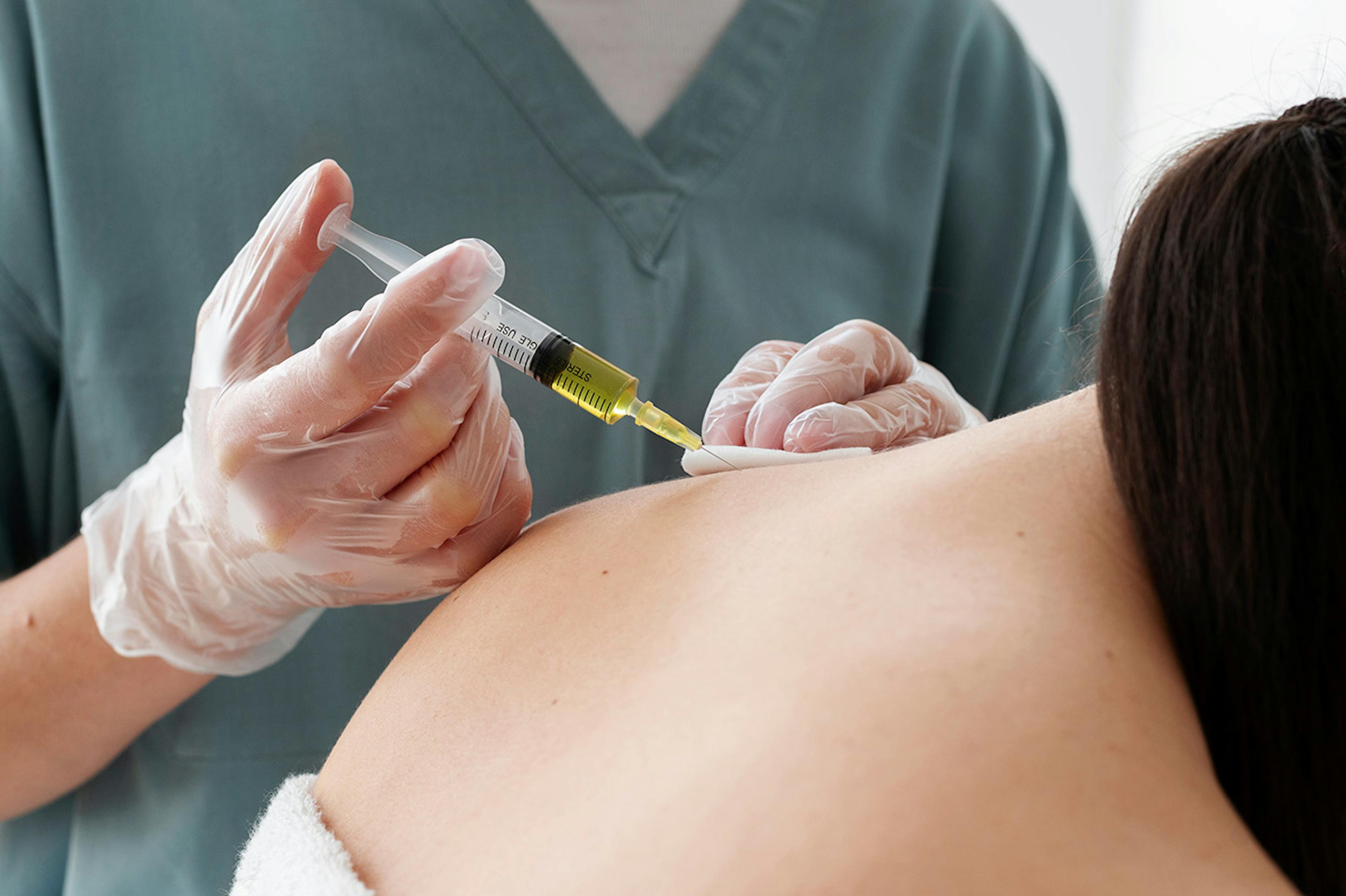 woman having traps botox injection