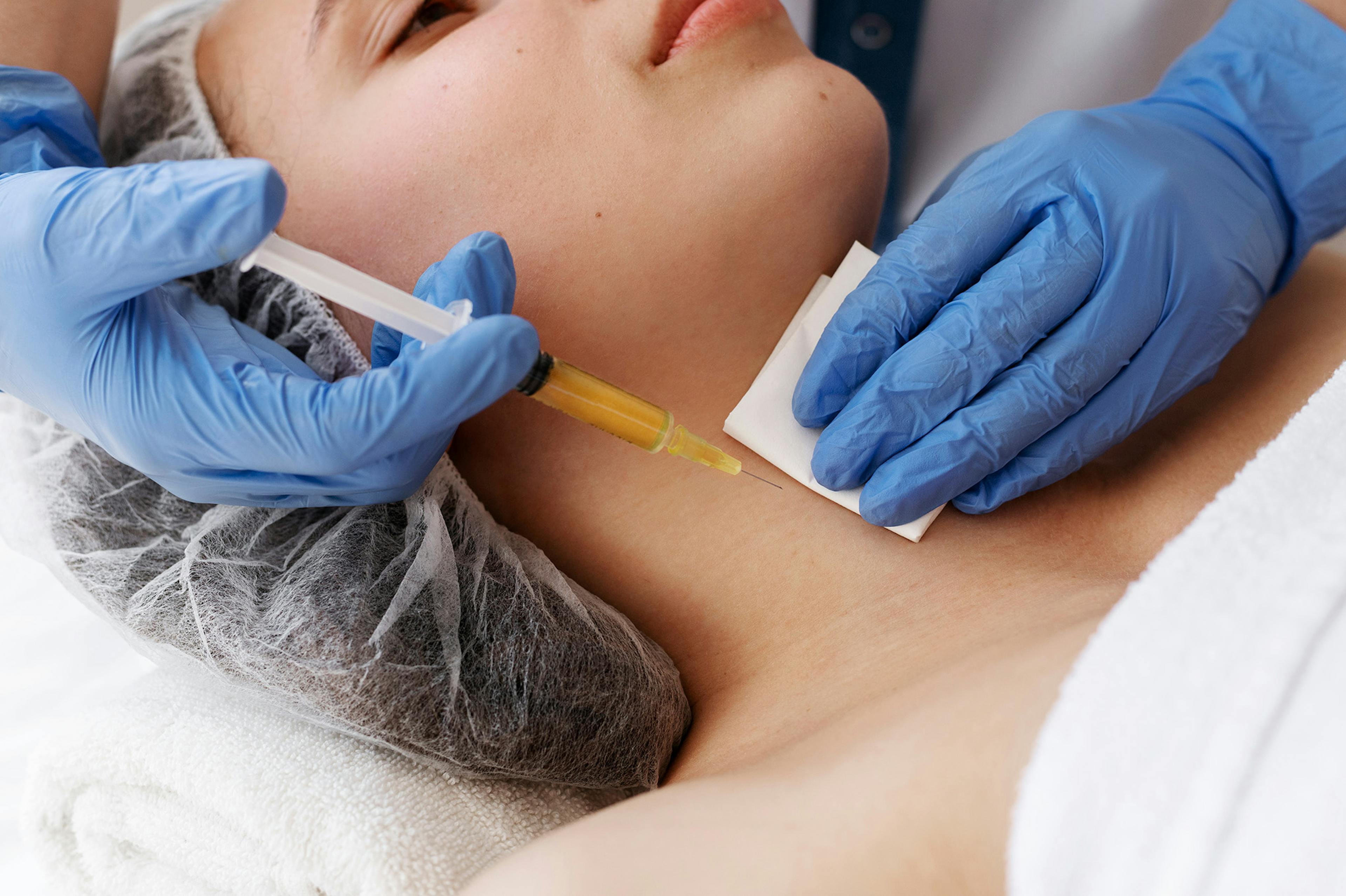 A female patient receiving Polynucleotides treatment on the neck area