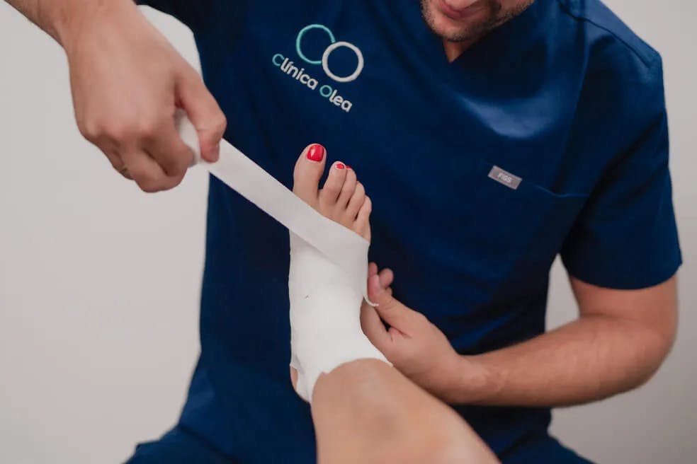 Fisioterapeuta tratando un tobillo en Clínica Olea