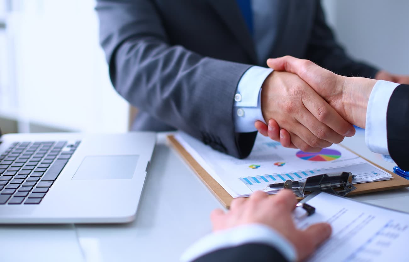 men shaking hands after licensing agreement deal