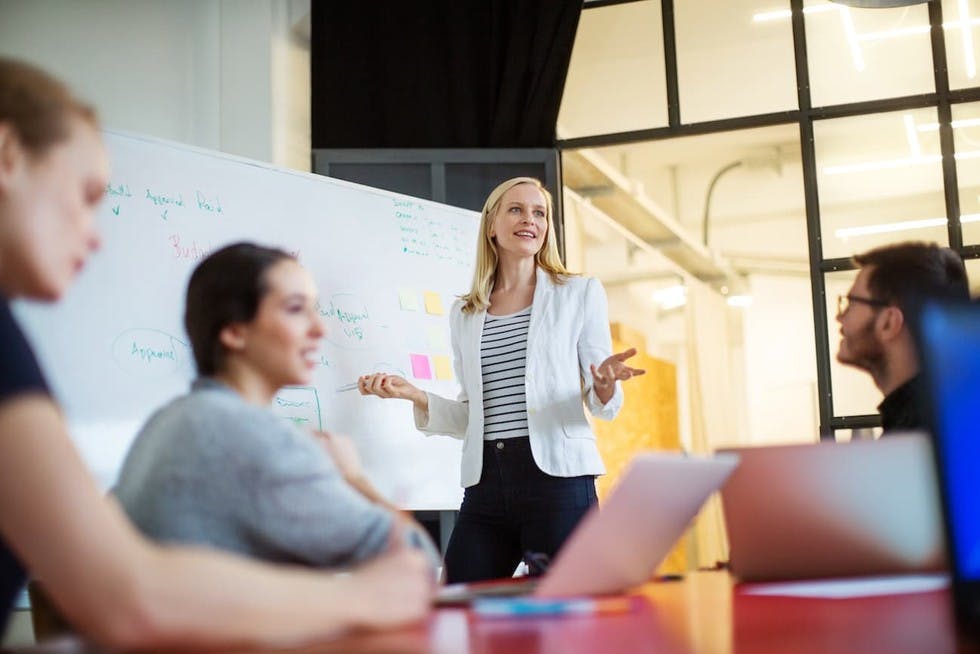 woman giving presentation with white board
