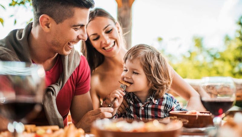 family listening to music and eating in restaurant