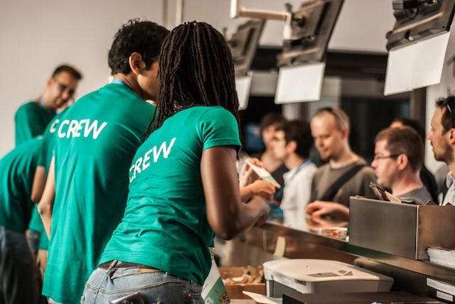 people in "crew" shirts working