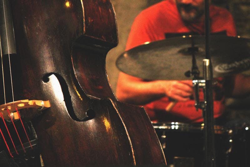 a cello and a person playing the drums