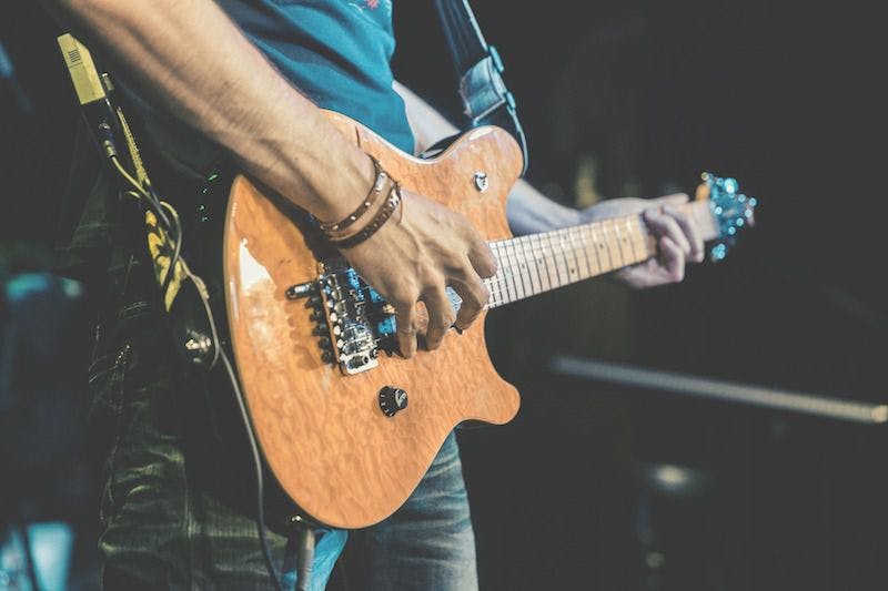 person playing an electric guitar