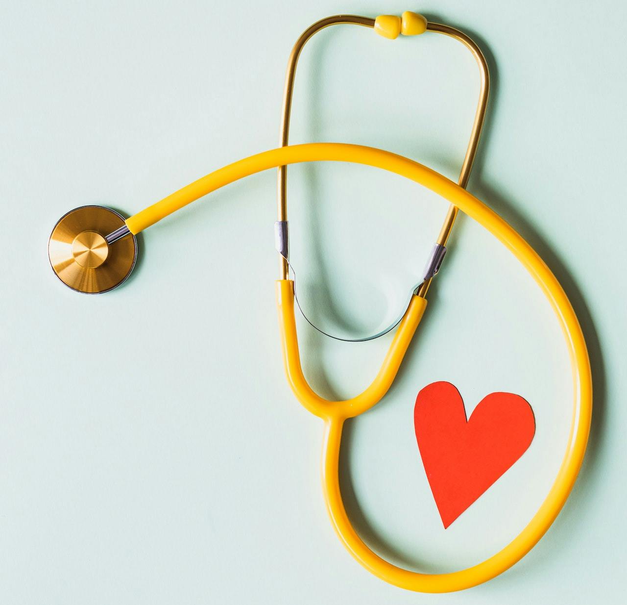 stethoscope and a paper cutout of a heart shape