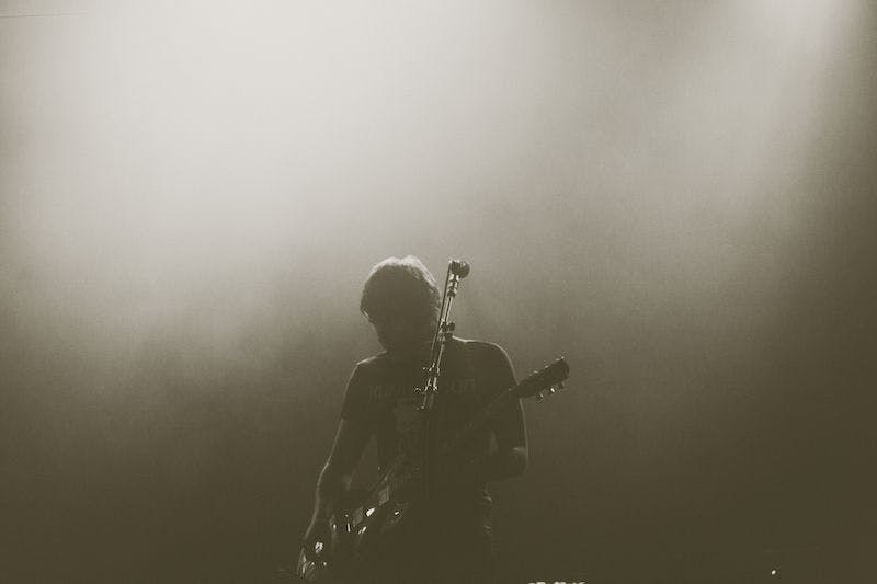 person playing guitar on stage