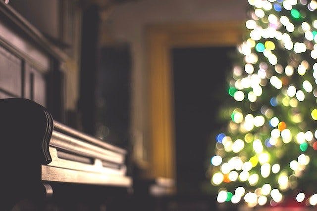 Christmas tree next to a piano