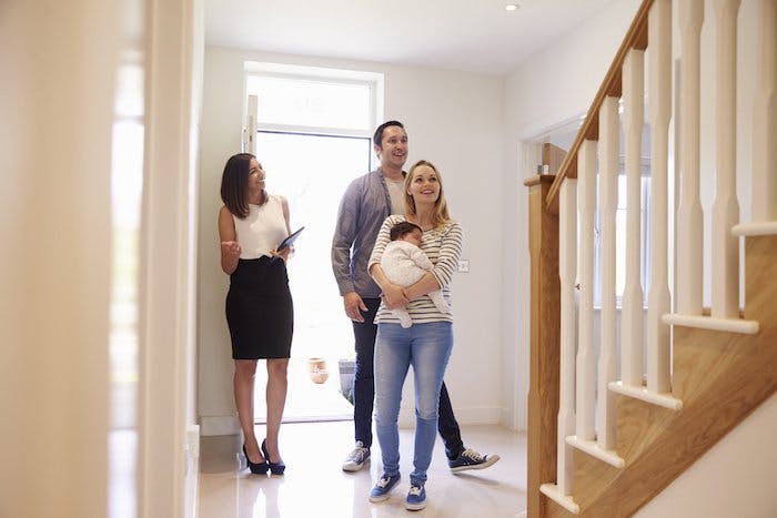 people touring a home with a real estate agent
