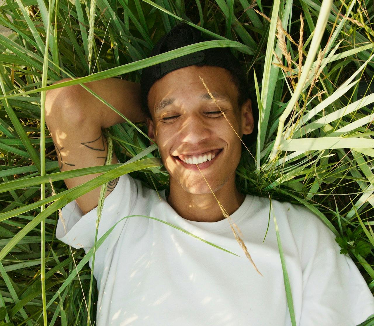 man smiling in grass