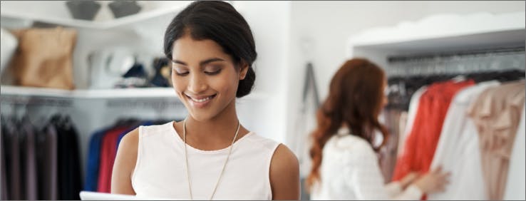 lady viewing tablet in clothing store