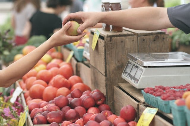purchasing fruit at a grocery store