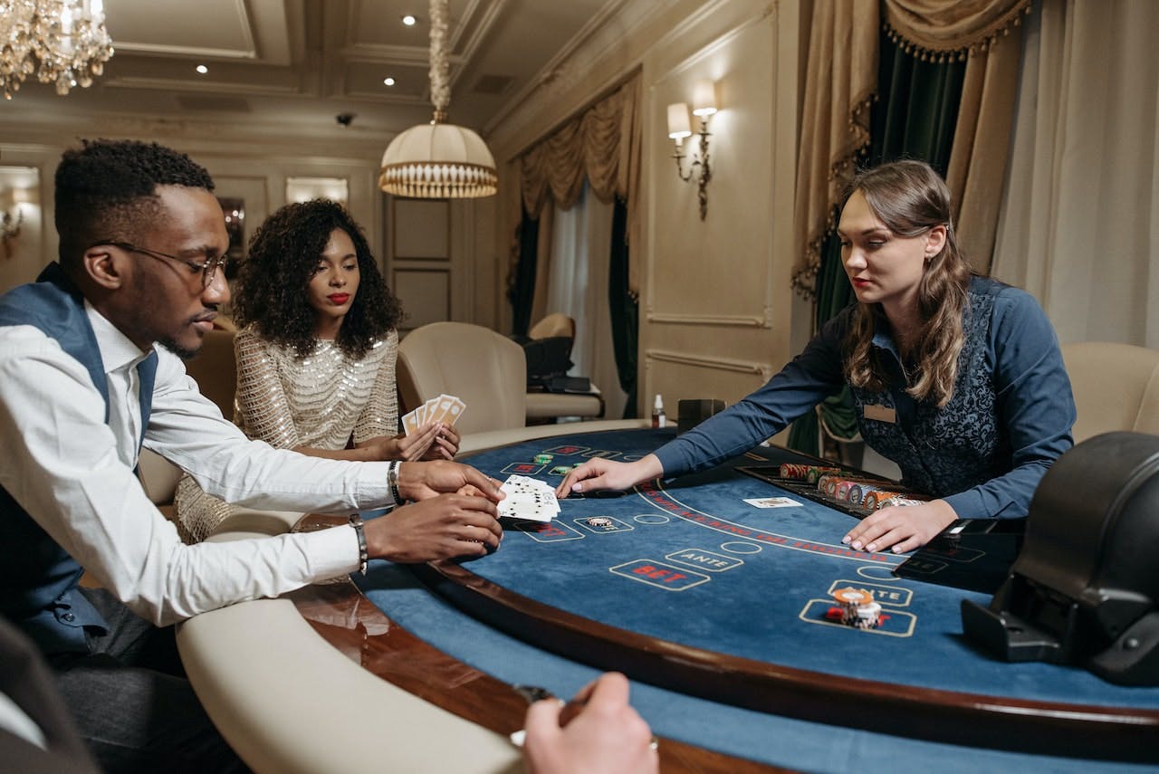 people playing cards at a poker table