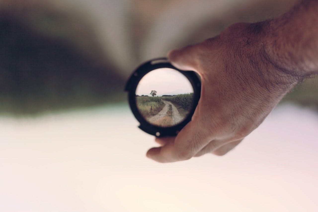 hand holding a camera lens