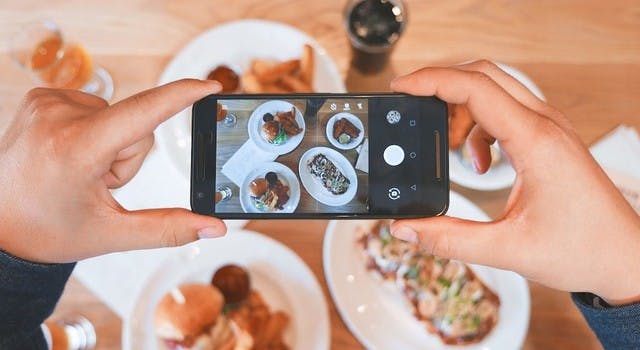 taking a picture of food at a restaurant